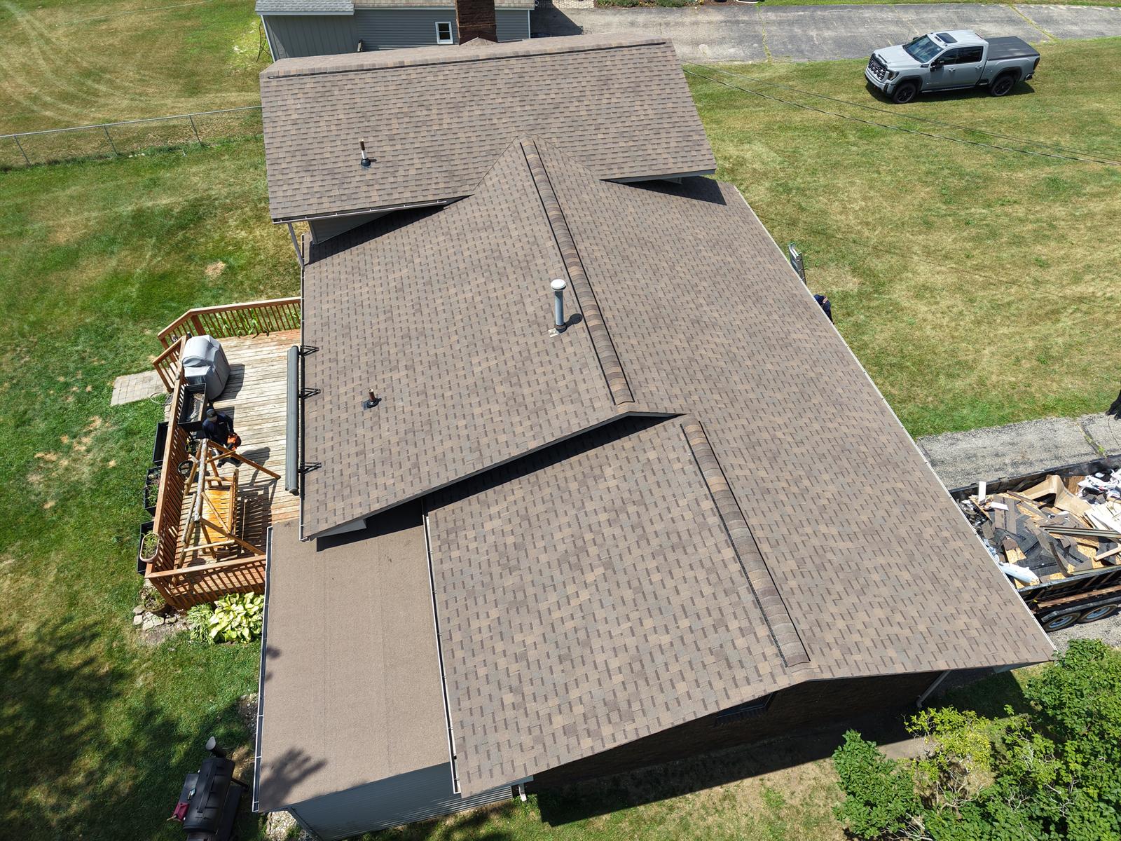 Get-R-Done Roofing completed project in Clarkston, Oakland County, Michigan — aerial view of full roof replacement with new seamless gutters