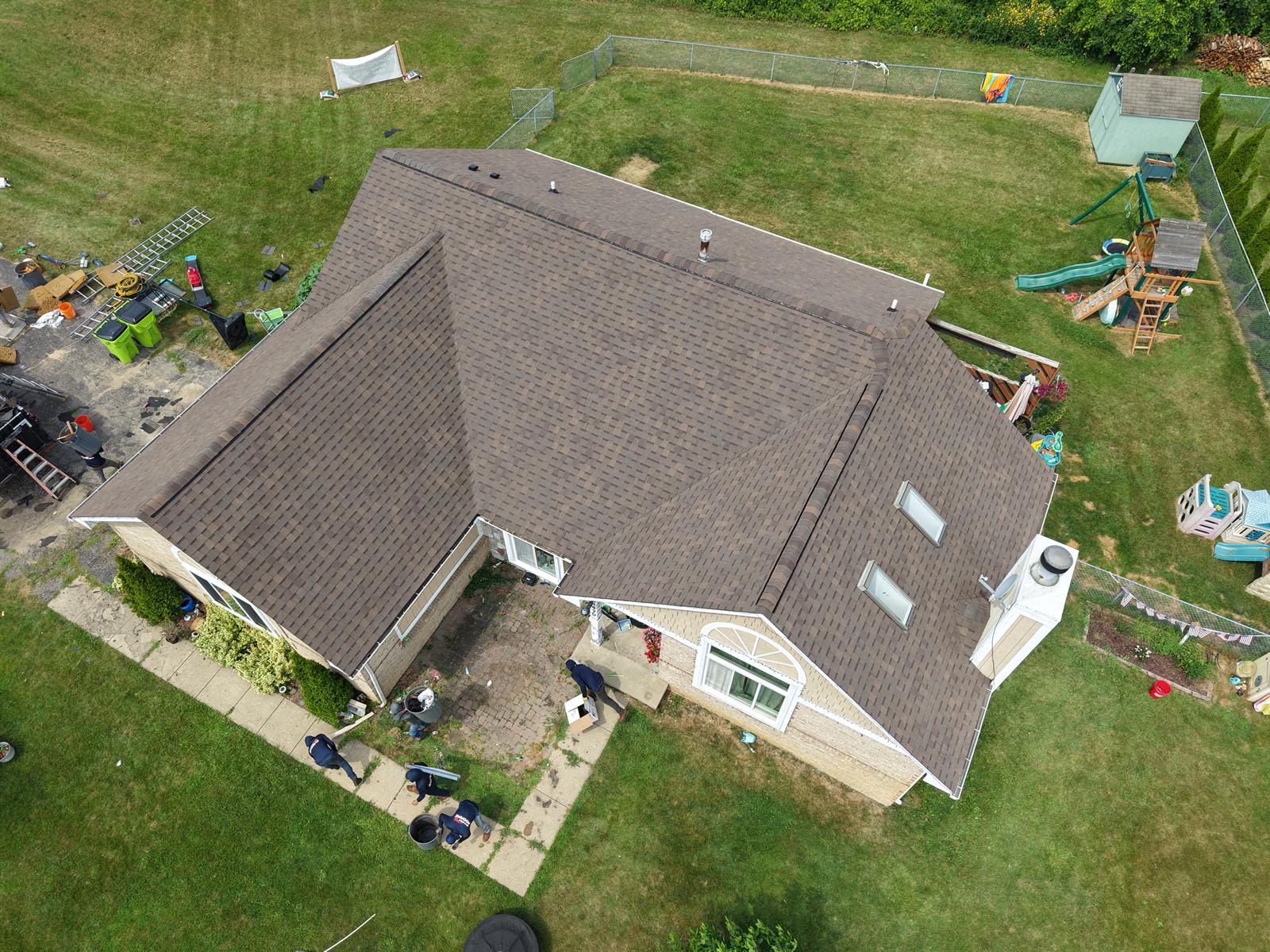Get-R-Done Roofing completed project in White Lake, Oakland County, Michigan — aerial view of steep-pitch roof replacement with new architectural shingles and skylights